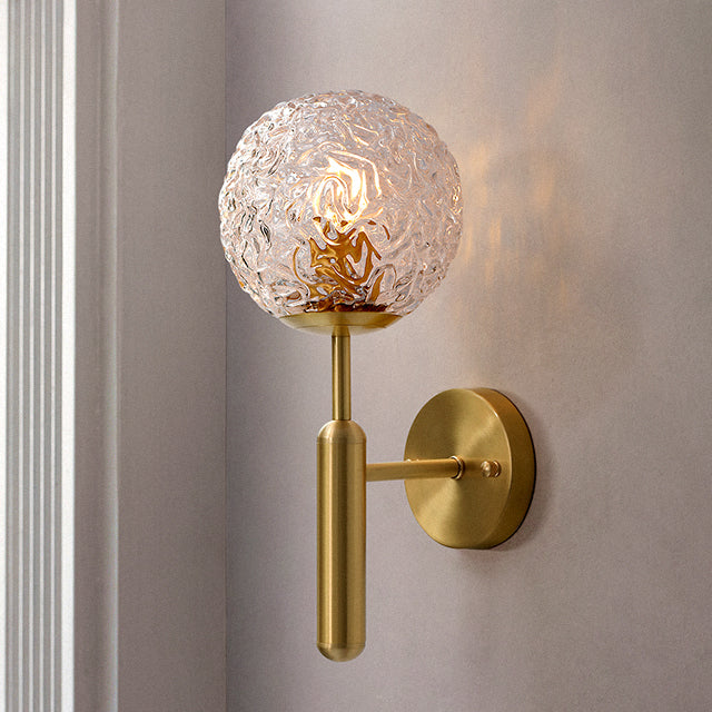 Gold and glass bulb wall light.