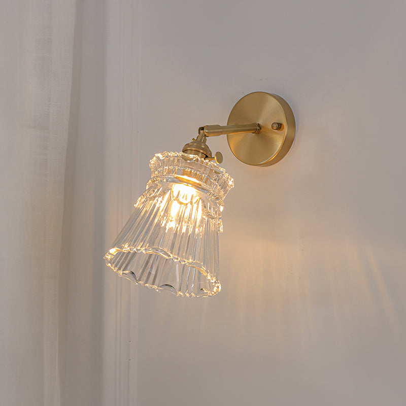 Vintage-style brass wall sconce with glass shade.