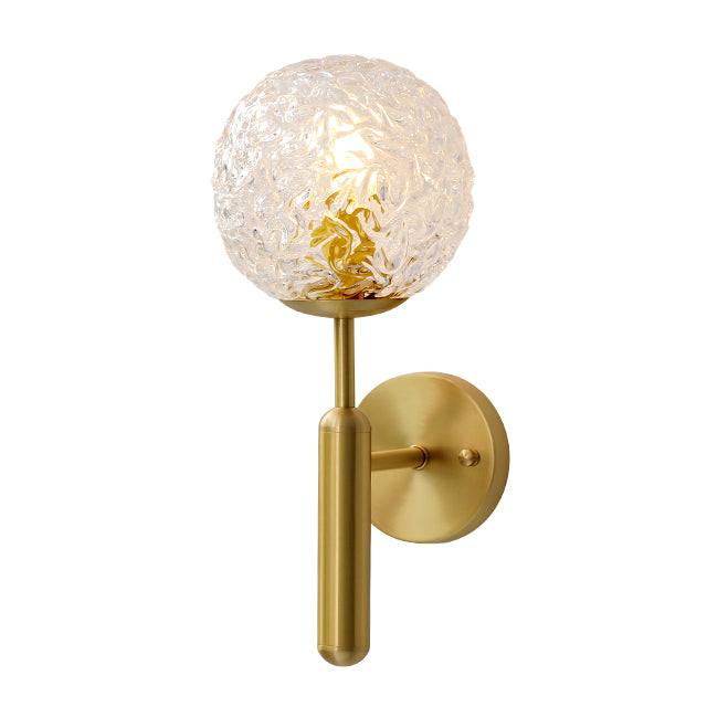 Gold and glass bulb wall lamp with white background