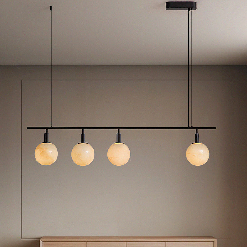 Contemporary spherical pendant lights illuminate a dining area